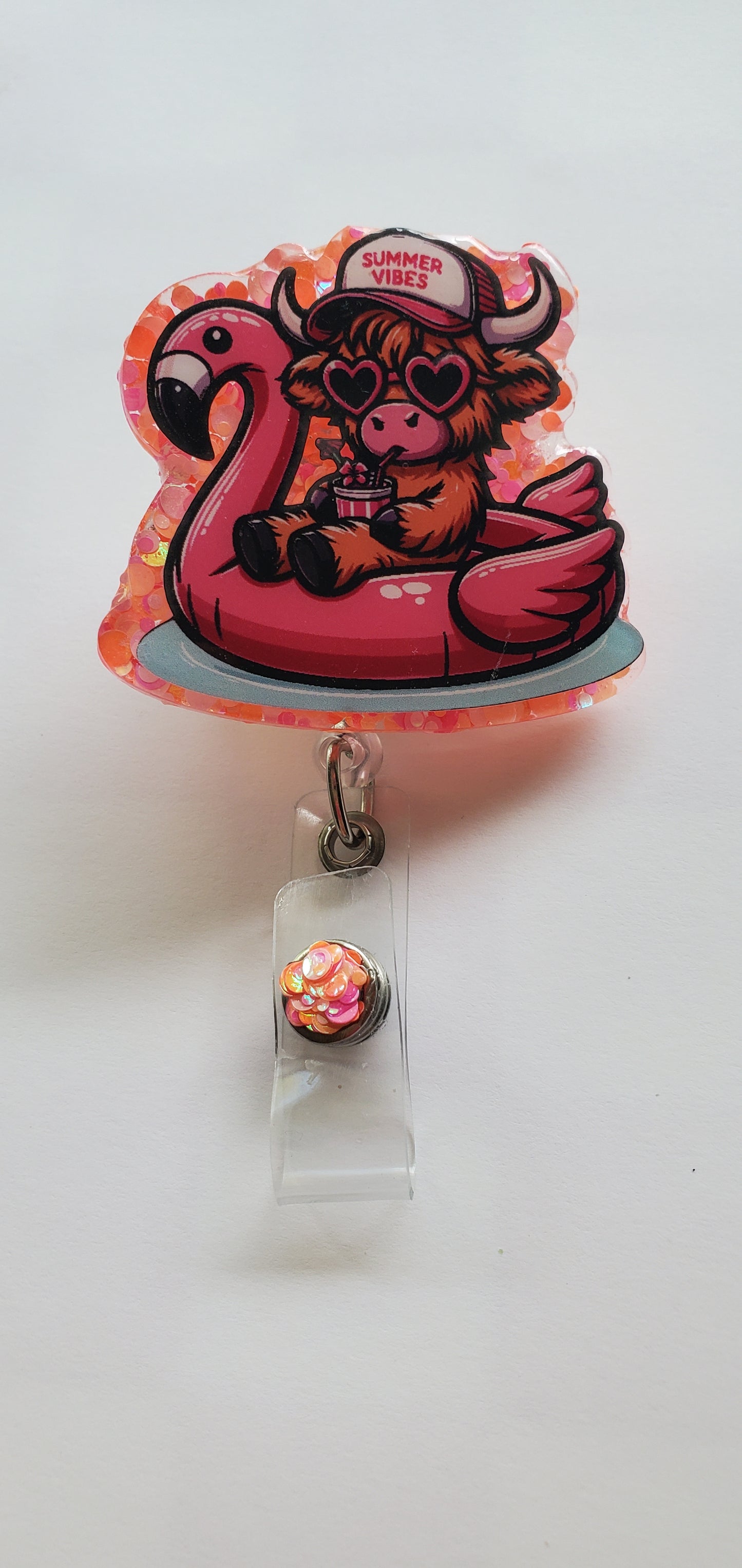 Floating Flamingo Highland Cow Badge Reel